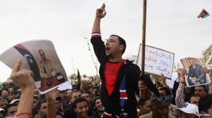 Men carrying pictures of former Libyan commander Khalifa Haftar protest against the General National Congress