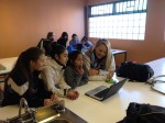 Amanda West (front), Melinda Szabo, & Qianming Wang (back) share their "Soy de Aqui" iMovies with students from Escuela Uruguay.