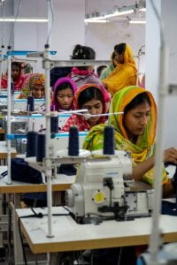 Women working at sewing machines in a subcontracting garment factory in Bangladesh
