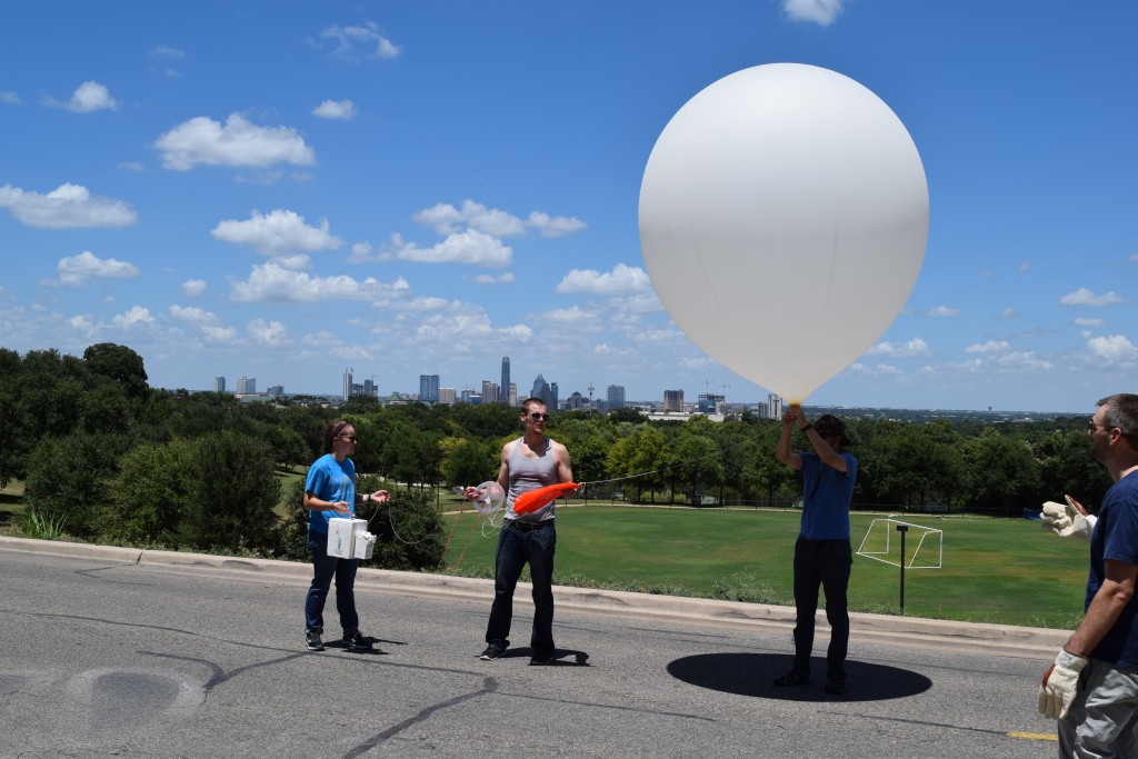 Preparing to release the balloon in front of Main Building with Austin in the background.
